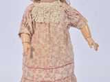 an old fashioned doll with a hat and dress on a white background