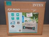 the box is open to show the contents of a robotic lawn mower
