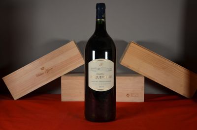 a bottle of wine sitting on a table next to two wooden boxes