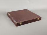 brown leather case with brass handles and handles on a white surface