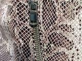 the zipper of a snake skin jacket with a zipper on it