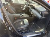 the interior of a car with the door open and the driver ' s seat down
