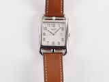 a watch that is sitting on a white surface