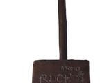 a small metal object with a wooden handle on it