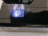 a sewing machine that has a blue light on it
