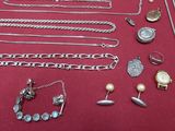 many different types of jewelry on a red table