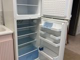 a white refrigerator with its door open in a kitchen