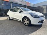 a white car parked in front of a building