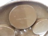 a close up of a metal pan with four pans inside of it