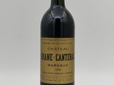 the bottle of wine is sitting on a white surface