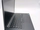 a laptop with a black keyboard sitting on a white surface