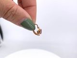 a person that is holding a ring in their hand