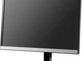 a computer monitor sitting on top of a desk next to a keyboard