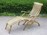 a wooden chair and a foot rest on the pavement