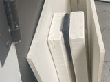 a white radiator that is next to a white stove