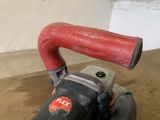 a red handle that is attached to a black and red machine