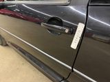 a car door handle with a sticker on the side of it