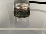 a glass container with a toothbrush on top of it