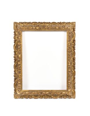 a gold frame on a white wall with a white background