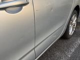 a silver car that is parked on the side of the road