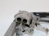 a gun that is sitting on a white table