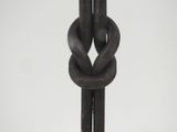 a close up of a metal chain with a knot on it