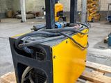 a close up of a yellow and black machine in a warehouse