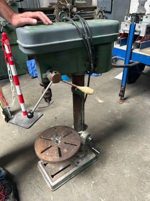 a man that is working on a machine in a garage