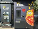 two vending machines that have pizzas on them
