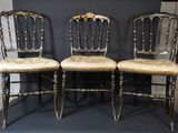 trois chaises aux finitions dorées sur fond noir