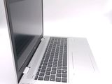 a silver laptop with a black keyboard on a white surface