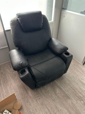 a black recliner that is sitting in a room