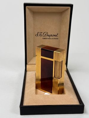 an image of a lighter in a box on a white surface