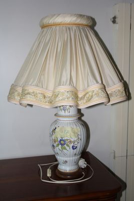 a lamp that is sitting on a table with a lamp shade on it