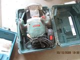 a green box with tools in it sitting on the floor