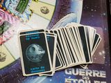 a lot of cards on the table with a picture of a space ship