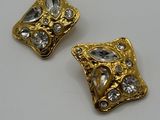pair of gold tone earrings with clear stones