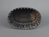 a silver plate with a flower design on it