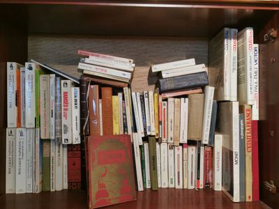 a book shelf with many books on it in a room