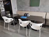 a table with four chairs and a table with a bottle of wine on it