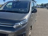 La camionnette grise est garée sur le parking.
