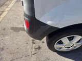 a small car that is parked on the side of the road