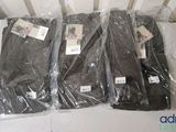 four pairs of men ' s pants are wrapped in plastic on a table