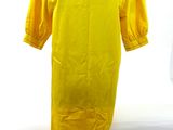 yellow dress on a mannequin stand against a white background