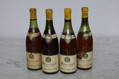 four bottles of wine are lined up on a marble surface