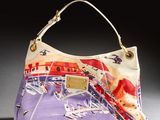 a purple purse with a picture of a train on it