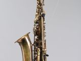 a saxophone hanging from a string in the air