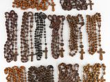 a close up of a bunch of rosary beads on a white surface