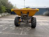 a yellow dump truck that is parked in a parking lot