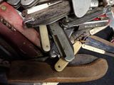 many different types of knives in a pile together